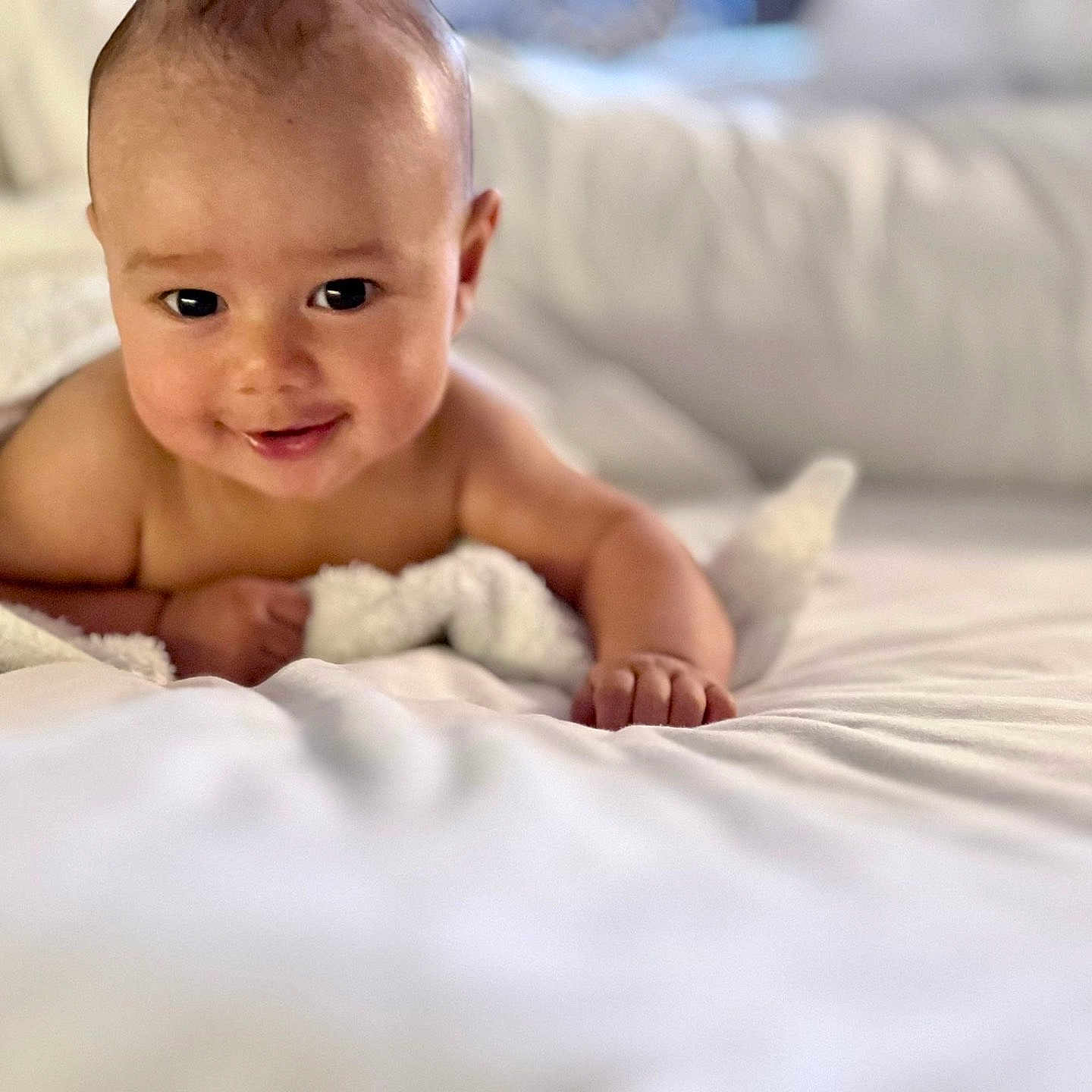 Elijah is registered to the contest to win money with this photo: baby, bed, blanket, child, comfort, cozy, cute, face, happy, indoors, infant, lying_down, person, portrait, skin, smile, soft, towel, white, young