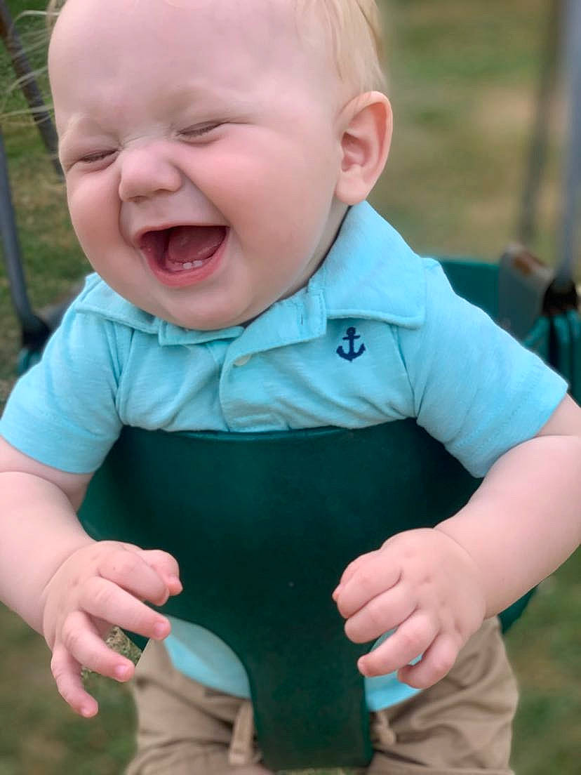 Maxton is registered to the contest to win money with this photo: baby, baby_toddler_clothing, cheek, chin, eye, facial_expression, finger, gesture, grass, green, hand, happy, head, nose, person, pink, skin, sleeve, smile, toddler