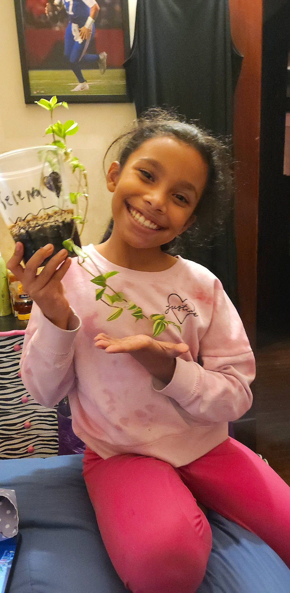 Selena joined the competition — help win amazing prizes! abdomen, child, comfort_food, finger, floral_design, flower, happy, herb, houseplant, human_leg, insect, joy, knee, person, plant, room, sitting, smile, t_shirt, thigh