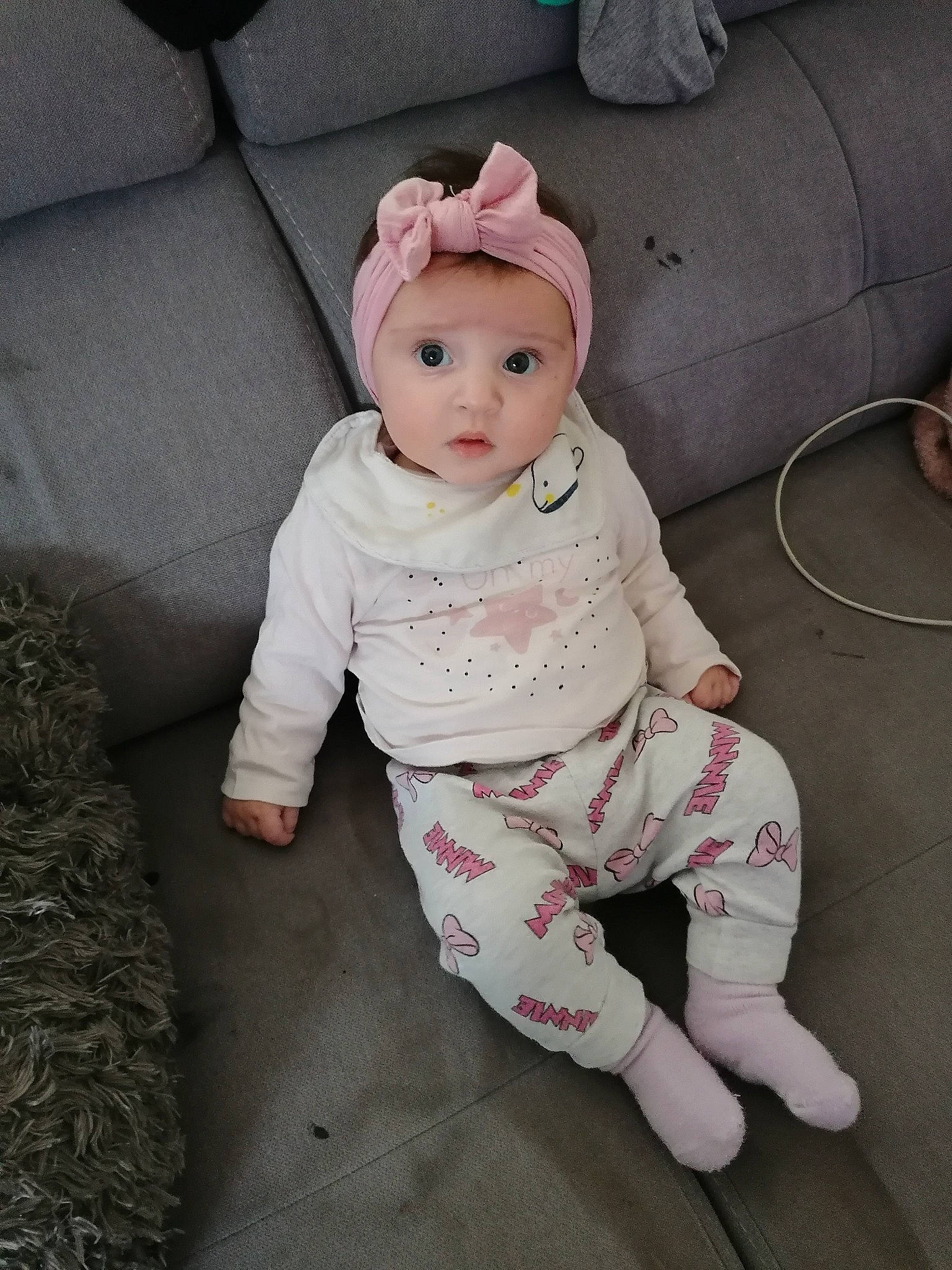 Katalyna participe au concours pour gagner de l'argent avec cette photo : baby, baby_toddler_clothing, cap, cheek, child, comfort, couch, eye, face, flooring, foot, fur, headgear, headwear, linens, pattern, person, pink, sitting, sleeve