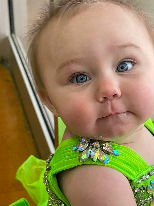 Aubree is registered to the contest to win money with this photo: baby_toddler_clothing, cheek, chin, ear, eye, eyebrow, eyelash, facial_expression, finger, forehead, hair, happy, head, iris, lip, mouth, neck, nose, organ, person