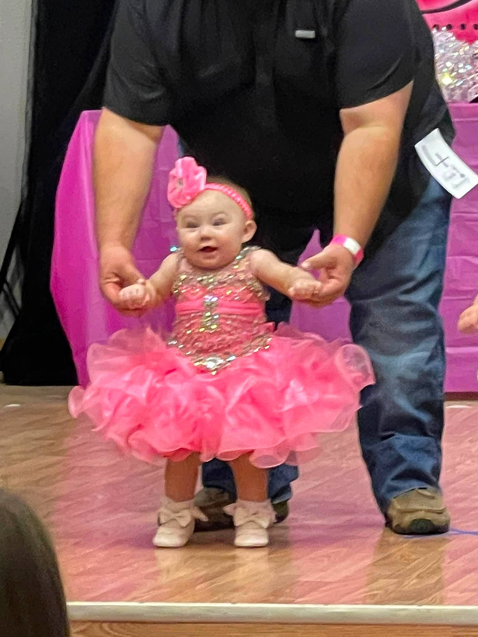 Aubree joined the competition — help win amazing prizes! baby, baby_toddler_clothing, child, curtain, entertainment, event, flooring, formal_wear, fun, gesture, happy, headwear, holding_hands, leisure, magenta, performance, performing_arts, person, pink, purple