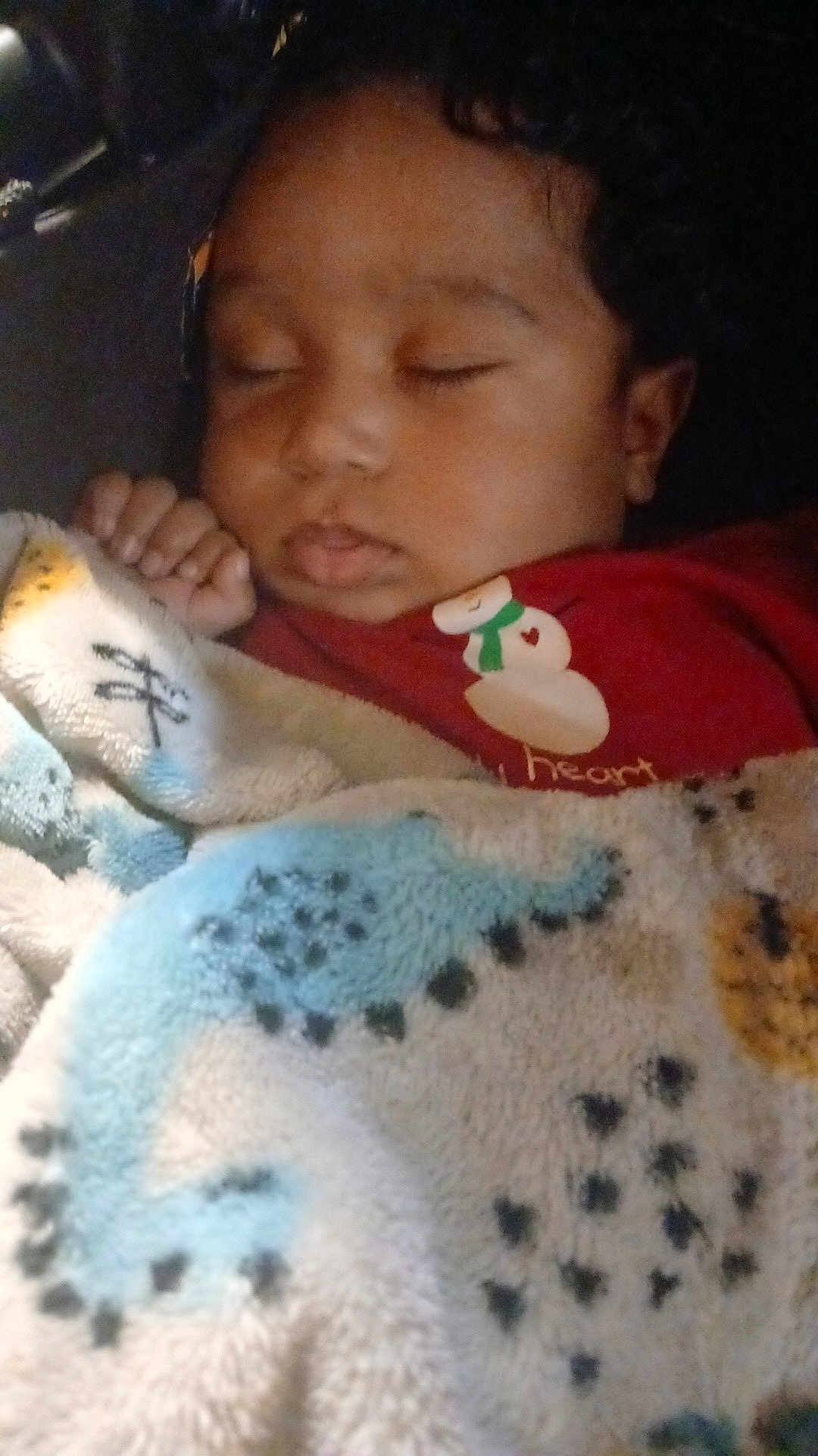 Johnny joined the competition — help win amazing prizes! child, sleeping, blanket, red_shirt, snowman, cozy, curly_hair, peaceful, indoors, portrait, face, hand, soft_light, closeup, warm_colors, resting, cute, young, toddler, nap