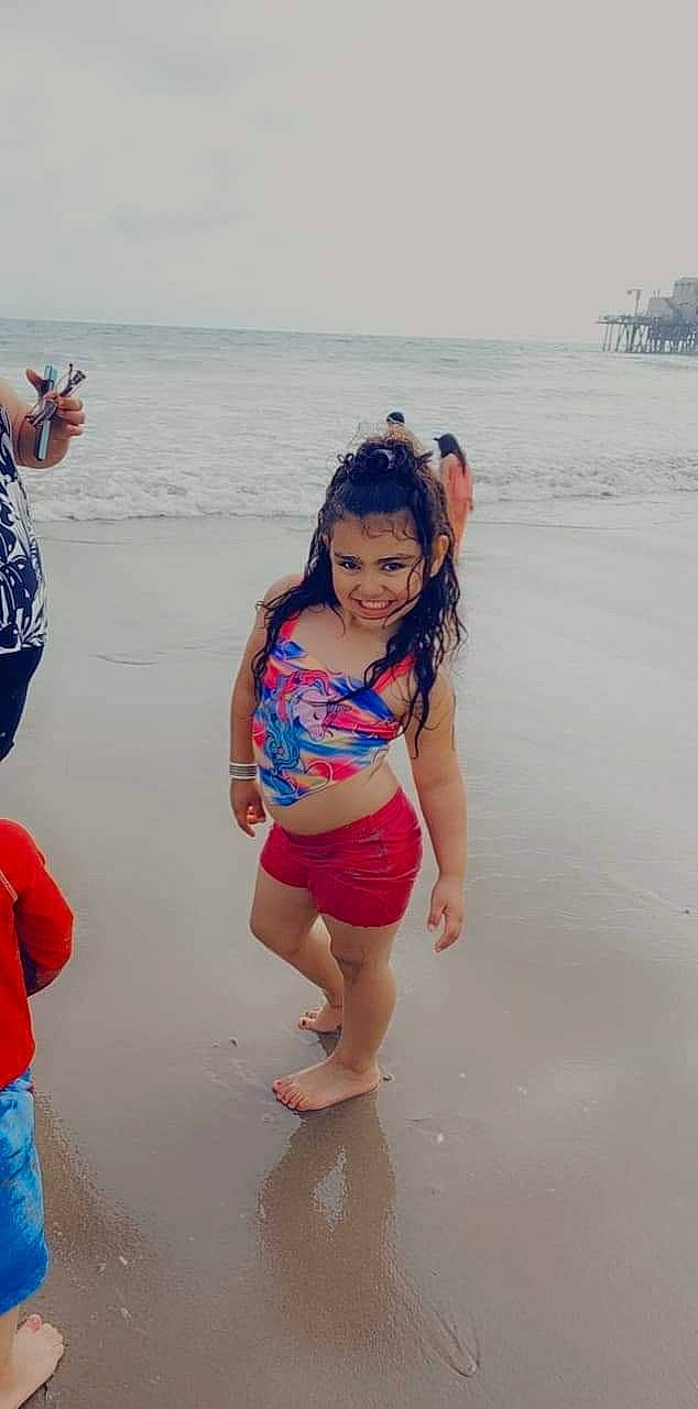Letizia is registered to the contest to win money with this photo: barefoot, beach, foot, fun, happy, human_leg, joy, leisure, people_on_beach, person, personal_protective_equipment, recreation, sand, shorts, sky, smile, swimwear, t_shirt, thigh, toddler