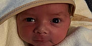 Xander is registered to the contest to win money with this photo: newborn, baby, towel, hooded_towel, face, eyes, wrapped, soft, cute, infant, cozy, portrait, child, clothing, fabric, texture, warm, smile, indoors, blanket