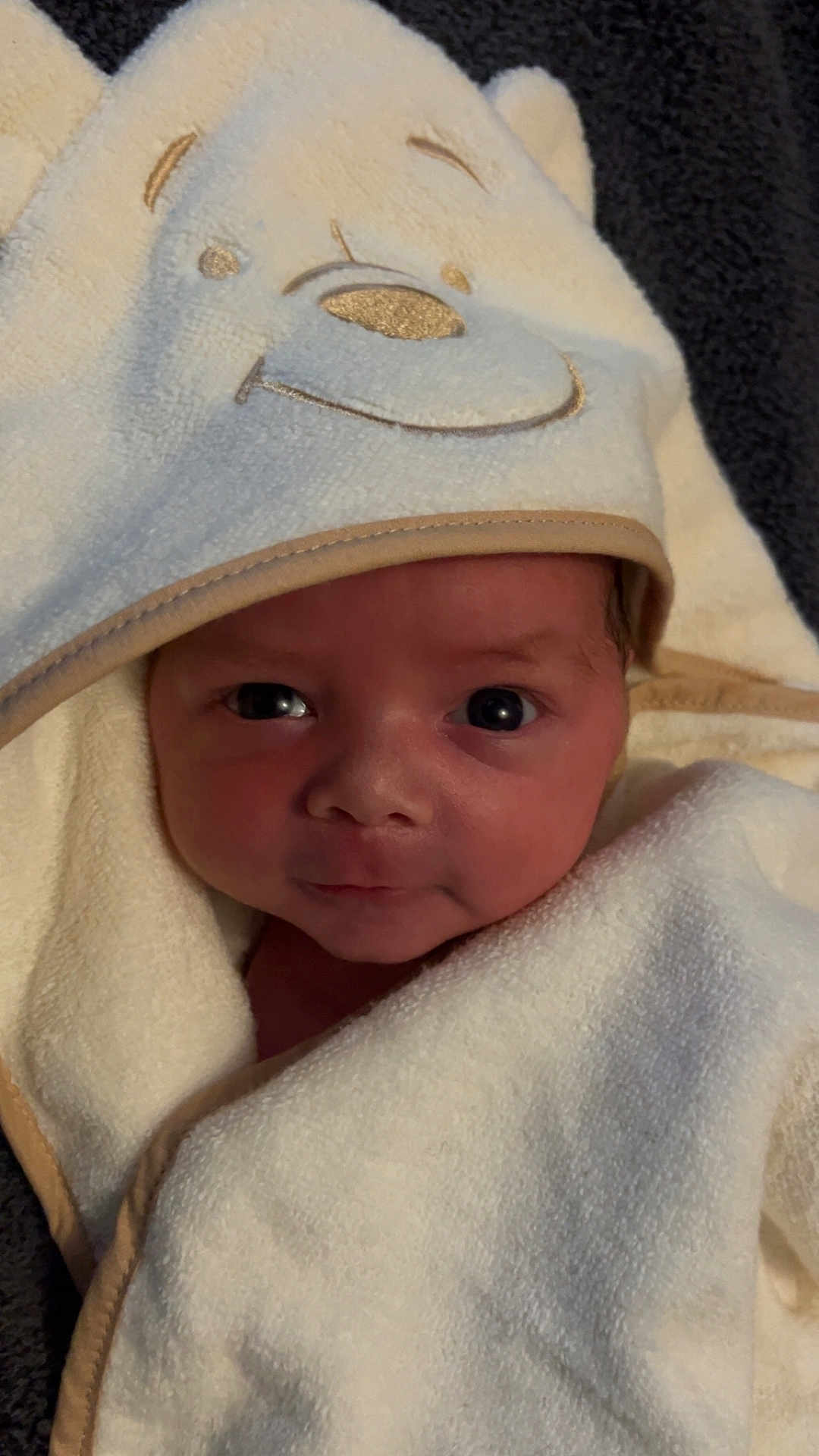 Xander is registered to the contest to win money with this photo: newborn, baby, towel, hooded_towel, face, eyes, wrapped, soft, cute, infant, cozy, portrait, child, clothing, fabric, texture, warm, smile, indoors, blanket