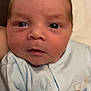 Xander is registered to the contest to win money with this photo: baby, newborn, infant, face, eyes, clothing, onesie, cute, soft, skin, portrait, closeup, child, young, head, expression, indoor, sleepwear, animal_print, babywear