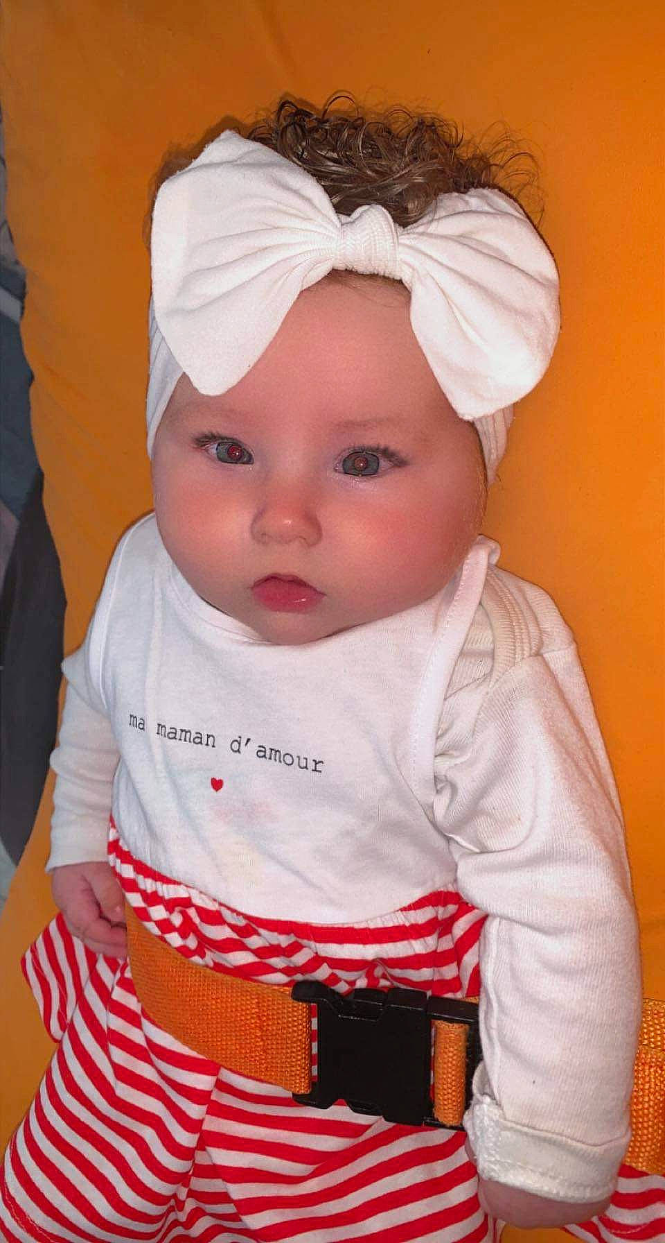 Lola a rejoint le concours — aidez-le/la à gagner de superbes lots ! baby, baby_toddler_clothing, cap, cheek, child, chin, eyelash, face, head, headband, headgear, headwear, lip, nose, outerwear, person, pink, skin, sleeve, t_shirt