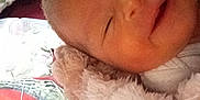 Emaleigh is registered to the contest to win money with this photo: baby, sleeping, smiling, blanket, pillow, quilt, face, infant, soft, closeup, cozy, child, resting, cute, comfort, bed, head, peaceful, indoors, warm