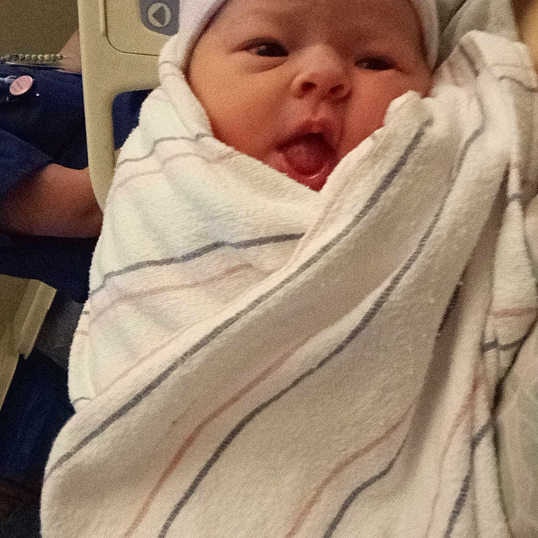 Emaleigh is registered to the contest to win money with this photo: baby, bed, blanket, child, cute, face, hat, healthcare, hospital, human, indoors, infant, medical, newborn, newborn_baby, parent, person, soft, tongue, wrapped