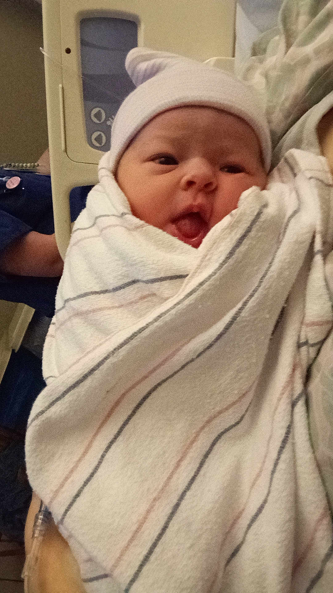 Emaleigh is registered to the contest to win money with this photo: newborn, baby, hospital, blanket, hat, face, person, infant, cute, wrapped, tongue, soft, bed, healthcare, parent, human, child, indoors, medical, newborn_baby