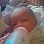 Emaleigh joined the competition — help win amazing prizes! baby, bottle, feeding, blanket, infant, face, hand, bed, comfort, sleepy, newborn, soft, peaceful, indoors, child, portrait, closeup, resting, nurturing, warm