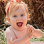 baby, child, happy, clapping, headband, red, outdoor, grass, haystack, water_droplets, skin, smile, expression, portrait, summer, sunlight, cute, bare_shoulders, playful, person