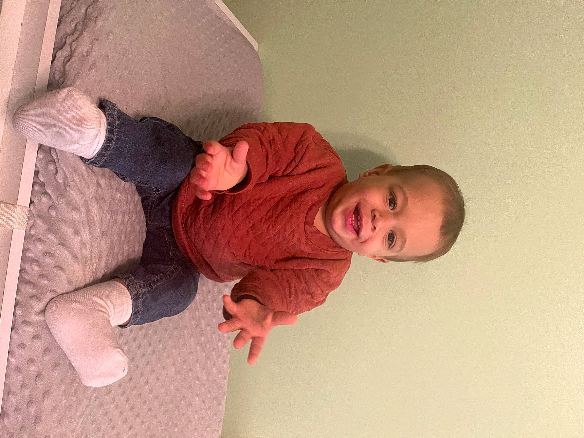 Cire is registered to the contest to win money with this photo: baby, baby_toddler_clothing, child, comfort, elbow, finger, flooring, foot, gesture, human_leg, joint, knee, linens, person, room, sitting, skin, sleeve, sock, toddler