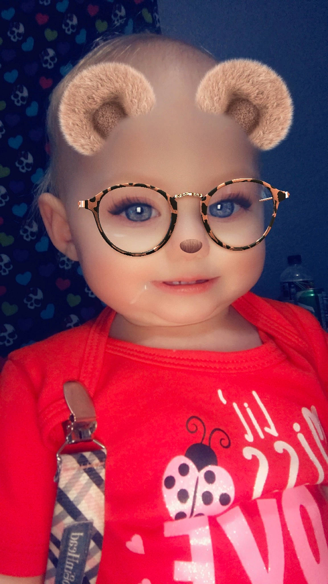 Kara is registered to the contest to win money with this photo: cheek, child, cool, ear, eye, eyewear, face, forehead, glasses, head, lip, nose, person, pink, red, smile, toddler, toy, vision_care