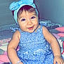 Maria participe au concours pour gagner de l'argent avec cette photo : baby, child, smiling, blue_dress, headband, bow, indoor, bed, blanket, plush_toys, happy, portrait, infant, cute, person, sitting, hand, face, young_child, toddler