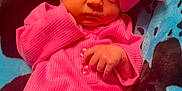 Mylee is registered to the contest to win money with this photo: baby, infant, pink_clothing, headwear, bow, blanket, blue, black, pattern, newborn, cute, portrait, lying_down, small_hands, indoors, soft_texture, warm, cozy, child, face