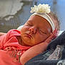 Mylee joined the competition — help win amazing prizes! baby, sleeping, headband, flower, pink_clothing, infant, cute, peaceful, portrait, child, hand, resting, soft_light, indoor, closeup, person, newborn, face, tender, cozy