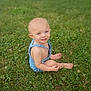 child, toddler, grass, outdoor, barefoot, blue_eyes, romper, greenery, sitting, person, lawn, nature, summer, cute, smiling, baby, skin, head, playful, daylight