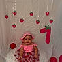Rebecca joined the competition — help win amazing prizes! baby, child, pink_hat, pink_dress, strawberry, balloon, red_balloon, birthday, number_one, decorations, smiling, sitting, celebration, party, cute, indoor, white_background, fabric, ribbons, festive