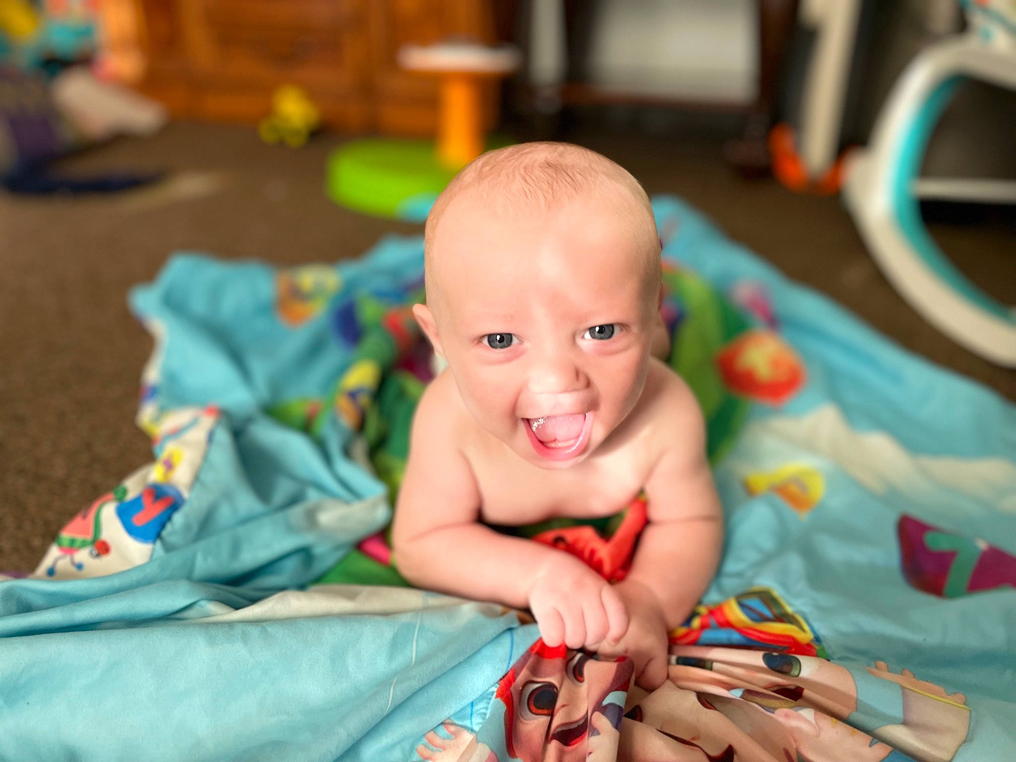 Parker is registered to the contest to win money with this photo: baby, baby_playing_with_toys, baby_products, cheek, child, eye, face, finger, flooring, fun, happy, iris, leisure, person, room, sitting, skin, smile, toddler, tummy_time