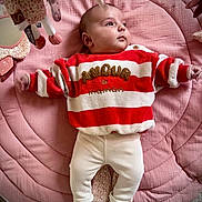 Elena participe au concours pour gagner de l'argent avec cette photo : baby, infant, child, red_sweater, striped_clothing, white_pants, pink_quilt, soft_toys, lying_down, indoor, cute, cozy, toddler, sleeping_mat, plush_toys, warm_colors, candid, portrait, gazing, comfortable