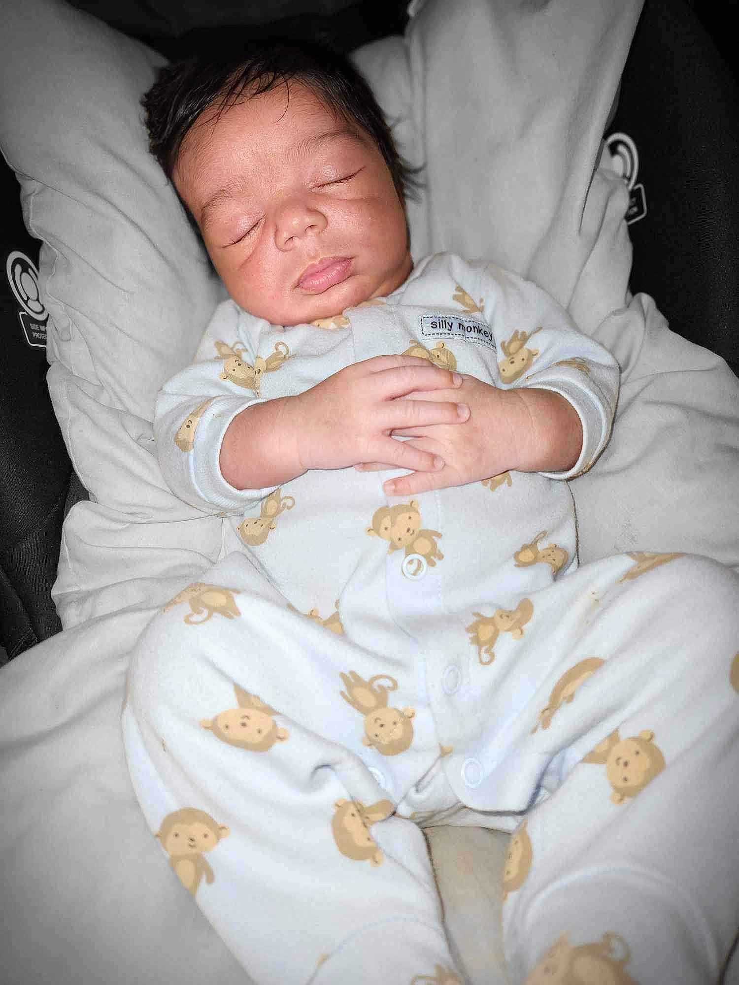 Blaze is registered to the contest to win money with this photo: baby, baby_products, baby_sleeping, baby_toddler_clothing, bedtime, cheek, child, comfort, event, finger, gesture, hand, linens, person, room, sitting, skin, sleeve, textile, thumb