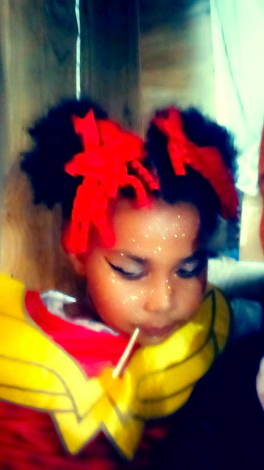 Ellianna is registered to the contest to win money with this photo: afro, artificial_hair_integrations, carmine, child, costume, doll, electric_blue, entertainment, event, eye, eyelash, fashion_design, fictional_character, fun, head, headwear, lip, lipstick, performing_arts, person