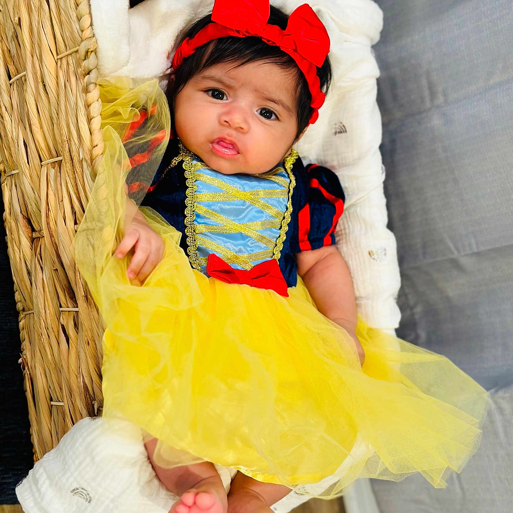 Aleina is registered to the contest to win money with this photo: baby, basket, bed, bodypart, bonnet, clothing, costume, dress, face, finger, flower, furniture, hand, hat, head, person, photography, plant, portrait, toy