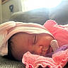 baby, sleeping, pacifier, pink_clothing, hat, indoor, soft_light, cozy, infant, closeup, face, cute, child, resting, blanket, apparel, young_child, portrait, newborn, peaceful