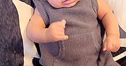 Jyaair joined the competition — help win amazing prizes! baby, infant, child, knitted_outfit, grey_clothing, socks, bed, pillow, pattern, heart_emoji, gesture, curious_expression, indoor, portrait, cute, cozy, young_child, person, seated, blanket