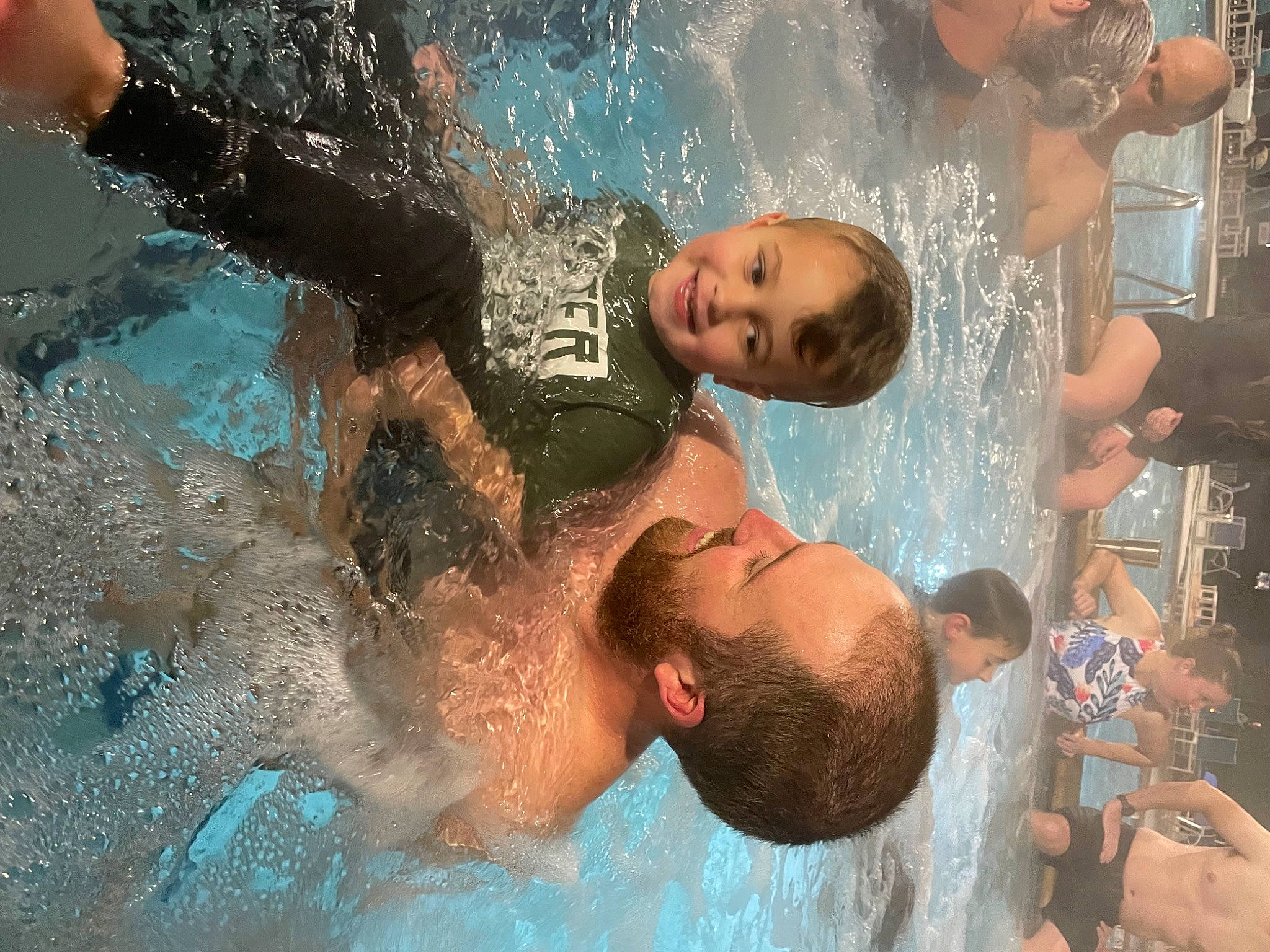 Archer is registered to the contest to win money with this photo: bathing, child, event, facial_expression, flash_photography, friendship, fun, happy, interaction, joy, leisure, muscle, people_on_beach, person, photograph, recreation, snapshot, summer, swimmer, swimming_pool