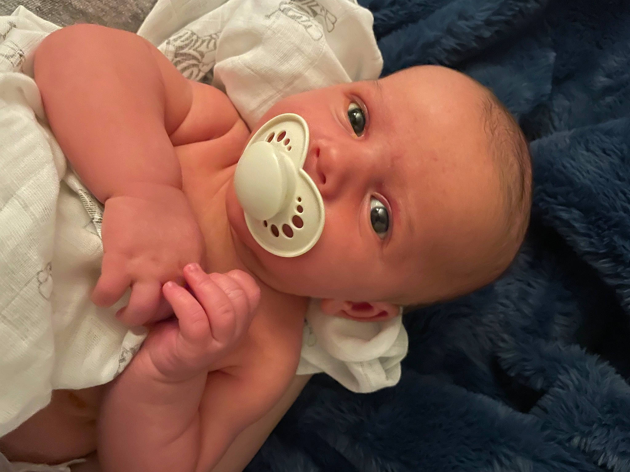 Fisher is registered to the contest to win money with this photo: baby, baby_toddler_clothing, cheek, comfort, eye, eyebrow, eyelash, finger, gesture, hand, happy, hat, human_body, lip, mouth, nail, nose, person, skin, thumb