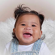 Kehlani is registered to the contest to win money with this photo: baby, child, smiling, happy, face, portrait, denim_overalls, pigtails, hair, cute, infant, white_background, soft_texture, clothing, young_child, cheerful, indoors, person, closeup, joyful