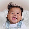baby, child, smiling, happy, face, portrait, denim_overalls, pigtails, hair, cute, infant, white_background, soft_texture, clothing, young_child, cheerful, indoors, person, closeup, joyful