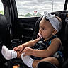 Asiya joined the competition — help win amazing prizes! baby, child, car_seat, pacifier, headband, white_socks, car_interior, window, cloudy_sky, seatbelt, infant, side_view, cute, young_child, safety_harness, portrait, travel, seat, vehicle, thinking