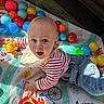 Léo participe au concours pour gagner de l'argent avec cette photo : baby, bib, child, colorful_balls, crawling, indoor, infant, jeans, lion_toy, patterned_mat, playmat, playpen_mesh, playtime, shadow, smile, striped_shirt, sunlight, surprised_face, teether, toy