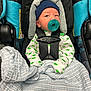 Milo joined the competition — help win amazing prizes! baby, pacifier, car_seat, blanket, infant, blue_hat, dinosaur_print, onesie, straps, safety_harness, fabric, comfort, child, cute, indoor, newborn, resting, portrait, soft, seat
