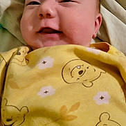 Milo joined the competition — help win amazing prizes! baby, bed, blanket, cheeks, child, closeup, clothing, comfort, cute, expression, face, happy, head, infant, portrait, sleepwear, smile, soft, toddler, yellow