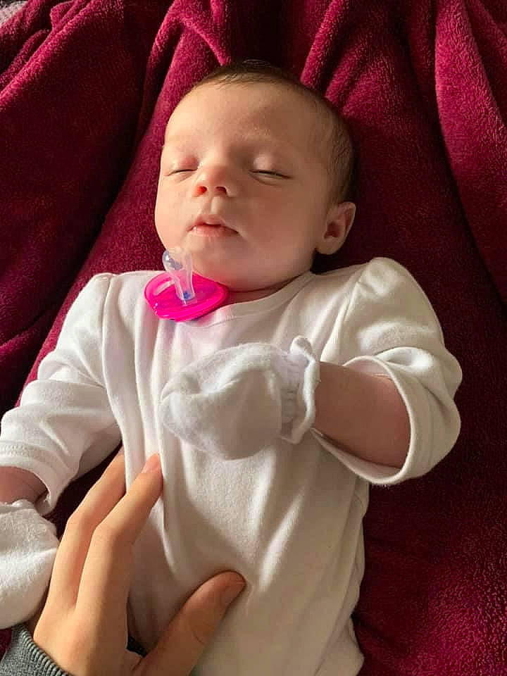 Belle is registered to the contest to win money with this photo: baby, cheek, child, mouth, person, pink, skin, smile, toddler