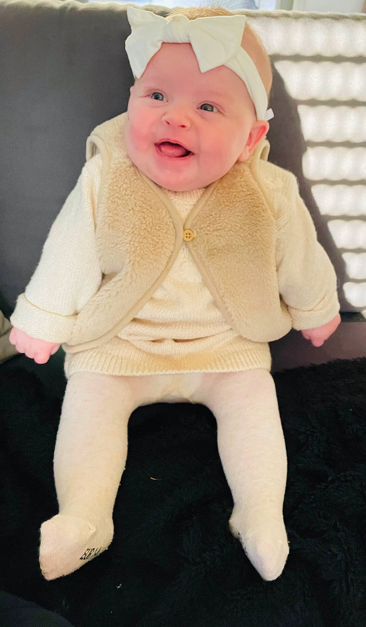 Emie participe au concours pour gagner de l'argent avec cette photo : baby, baby_laughing, baby_toddler_clothing, beanie, cap, cheek, collar, costume_hat, eye, face, fashion_accessory, fur, happy, head, headwear, human_body, outerwear, person, sitting, sleeve