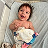 Michael is registered to the contest to win money with this photo: baby, blanket, child, comfort, cute, diaper, expression, face, hand, happy, head, indoors, infant, lying_down, playful, plush_toy, skin, smiling, soft_texture, toddler