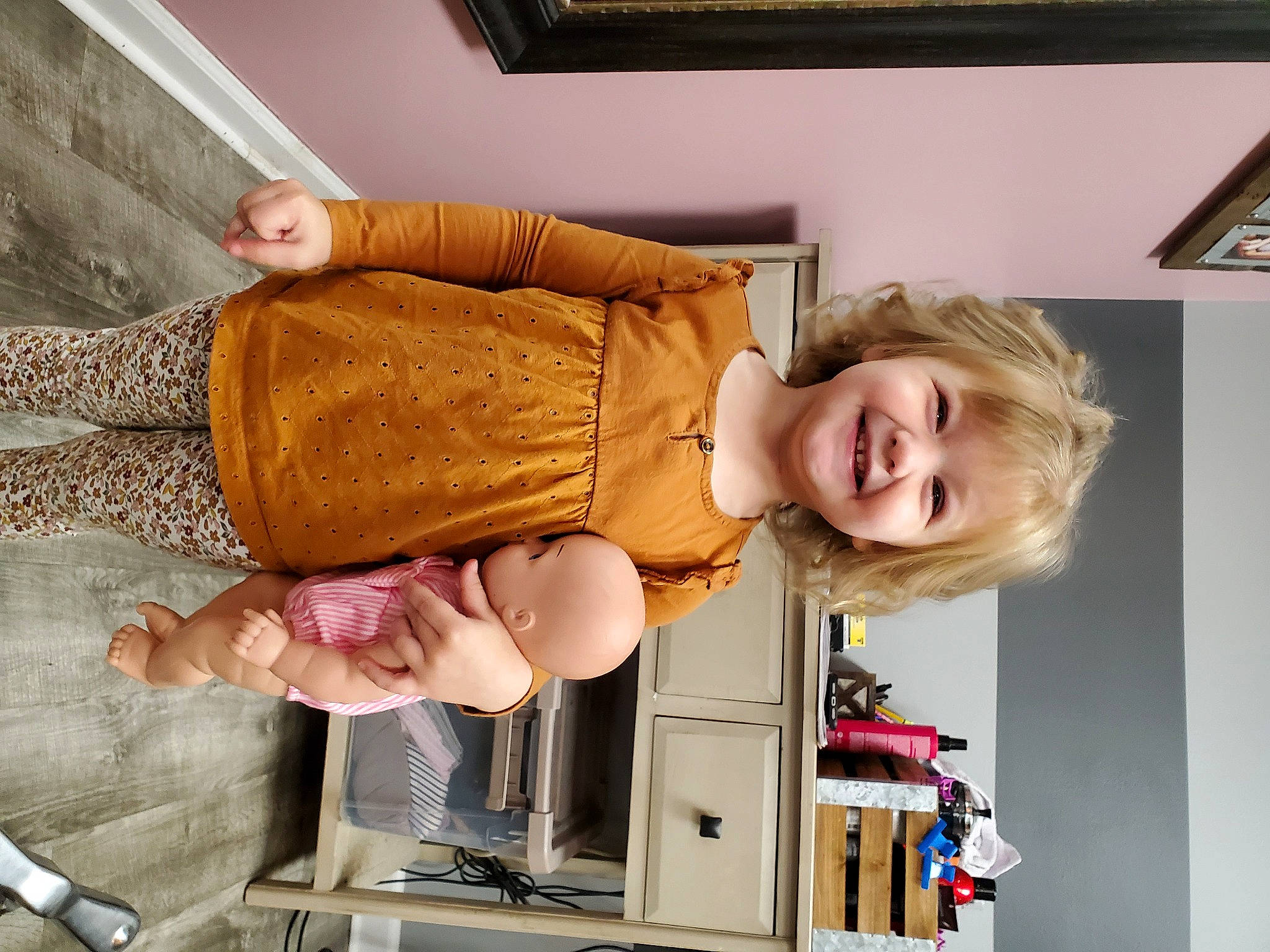 Elliott is registered to the contest to win money with this photo: baby, baby_products, building, cabinetry, child, comfort, drawer, fun, happy, human_leg, joy, pattern, person, picture_frame, room, sitting, smile, tableware, thigh, toddler