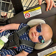 Carter joined the competition — help win amazing prizes! baby, sunglasses, car_seat, shopping_cart, baby_bottle, hand, striped_clothing, infant, child, seat_belt, safety, retail, shopping, toddler, cute, protective_hand, blue_clothing, reflection, casual, portrait