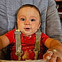 Mavrick is registered to the contest to win money with this photo: baby, high_chair, messy, food, mashed_food, red_shirt, blue_eyes, face, hands, child, indoor, feeding, cute, infant, smudge, expression, seat_belt, portrait, curious, toddler