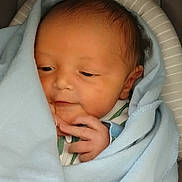 Twahn is registered to the contest to win money with this photo: newborn, baby, blanket, blue_blanket, infant, wrapped, sleepy, soft, cute, face, hand, skin, portrait, closeup, indoors, child, baby_clothes, head, peaceful, resting