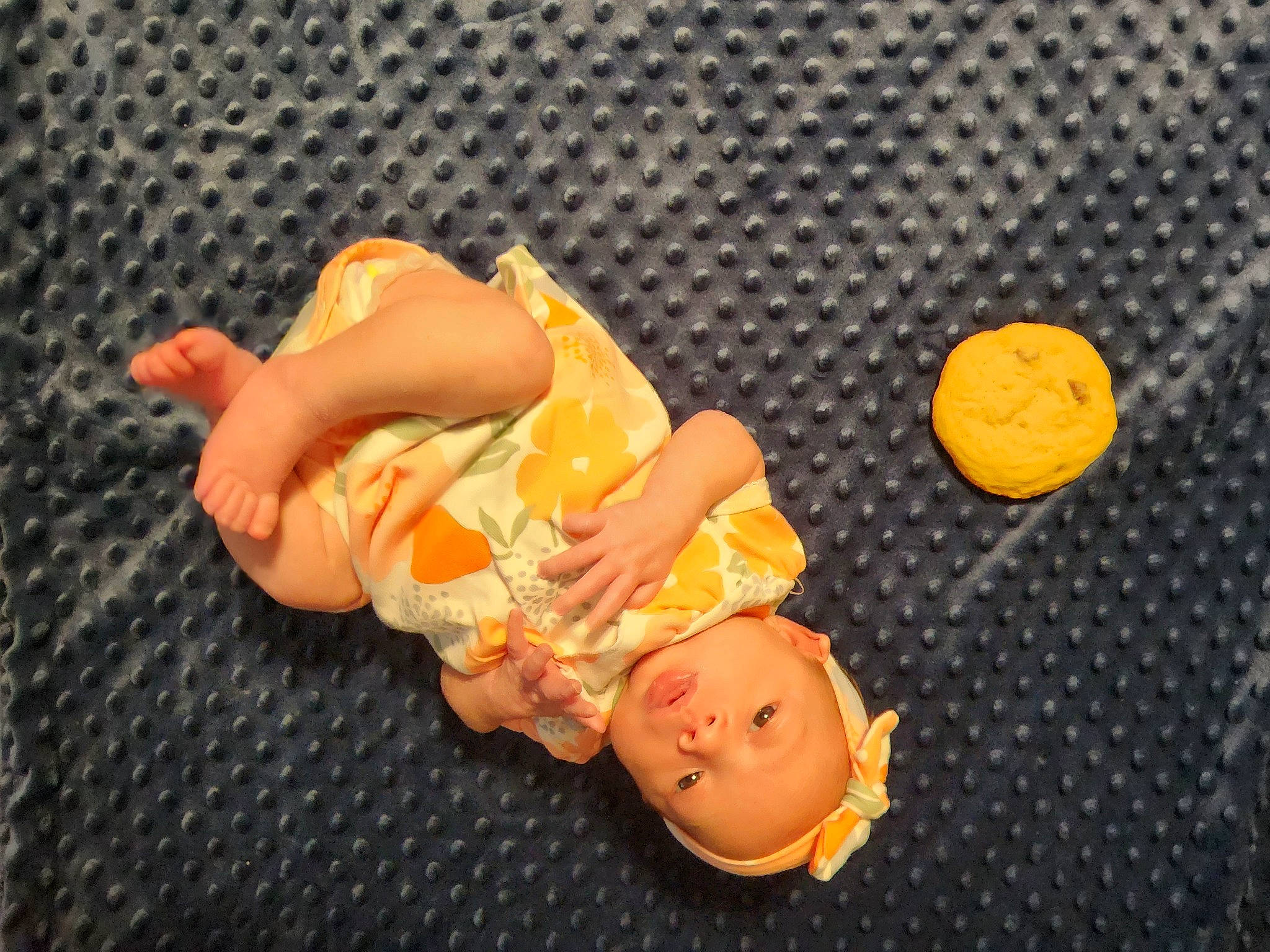 Adalynn is registered to the contest to win money with this photo: baby, baby_products, baby_toddler_clothing, baby_toys, child, doll, figurine, flooring, fun, orange, pattern, peach, person, thumb, toddler, toy, wood