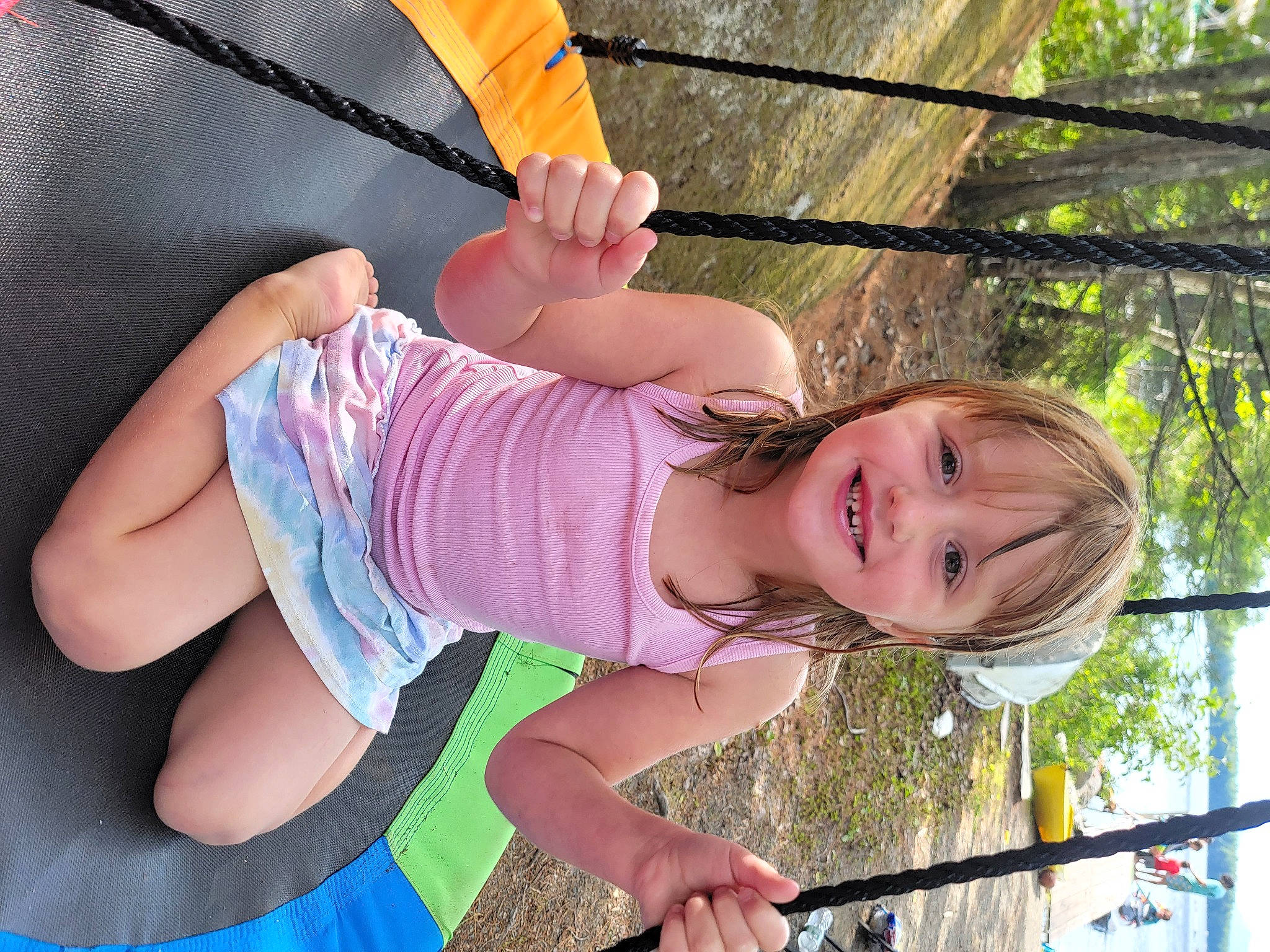 Khloe is registered to the contest to win money with this photo: arm, child, eye, finger, fun, grass, hand, happy, joy, leisure, people_in_nature, person, pink, plant, recreation, skin, smile, summer, thigh, toddler