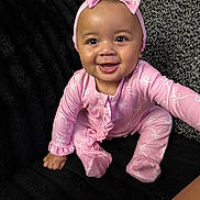 Senia is registered to the contest to win money with this photo: baby, child, infant, smiling, happy, portrait, pink_outfit, headband, bow, butterfly_pattern, sitting, couch, blanket, black_background, indoor, cute, face, eyes, baby_girl, photography