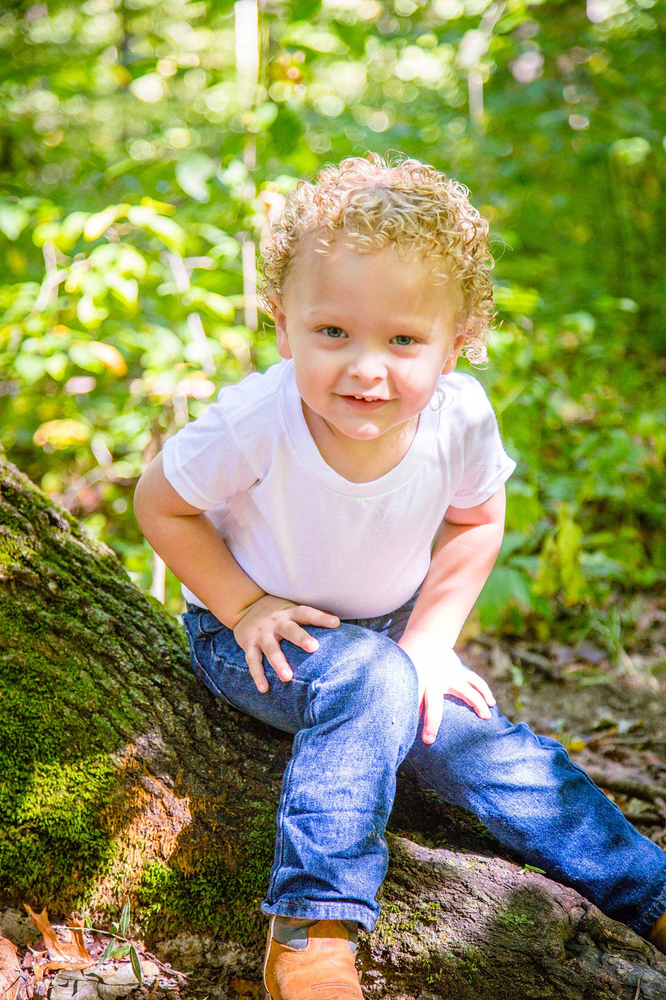 Brantley is registered to the contest to win money with this photo: baby_toddler_clothing, beauty, child, clothing, denim, electric_blue, forest, fun, grass, happy, jeans, joy, leaf, leisure, people_in_nature, person, plant, sitting, smile, sunlight